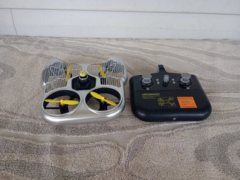 Toy RC racing drone with white frame and yellow propellers plus black remote controller