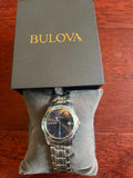 Bulova quartz wristwatch with blue dial, date window, and stainless steel bracelet