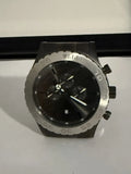 Men's quartz wristwatch with black dial, chronograph-style subdials, and metal case