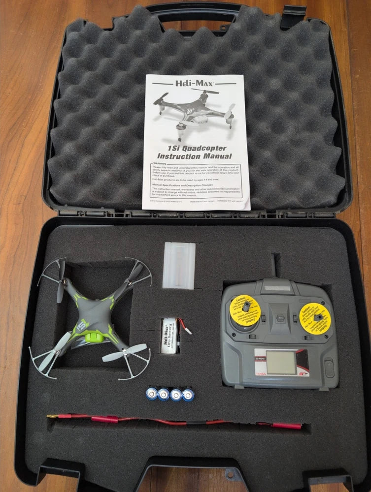 Quadcopter drone kit case with instruction manual, drone and controller