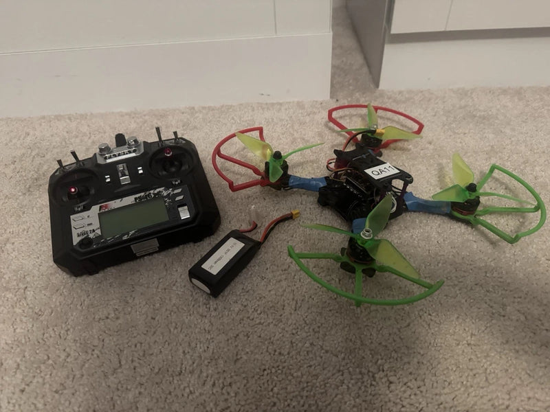 FPV drone setup with FlySky FS16 controller and 3S battery pack