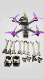 Purple-prop FPV freestyle quadcopter with motor mounts and frame parts, assembled and extras