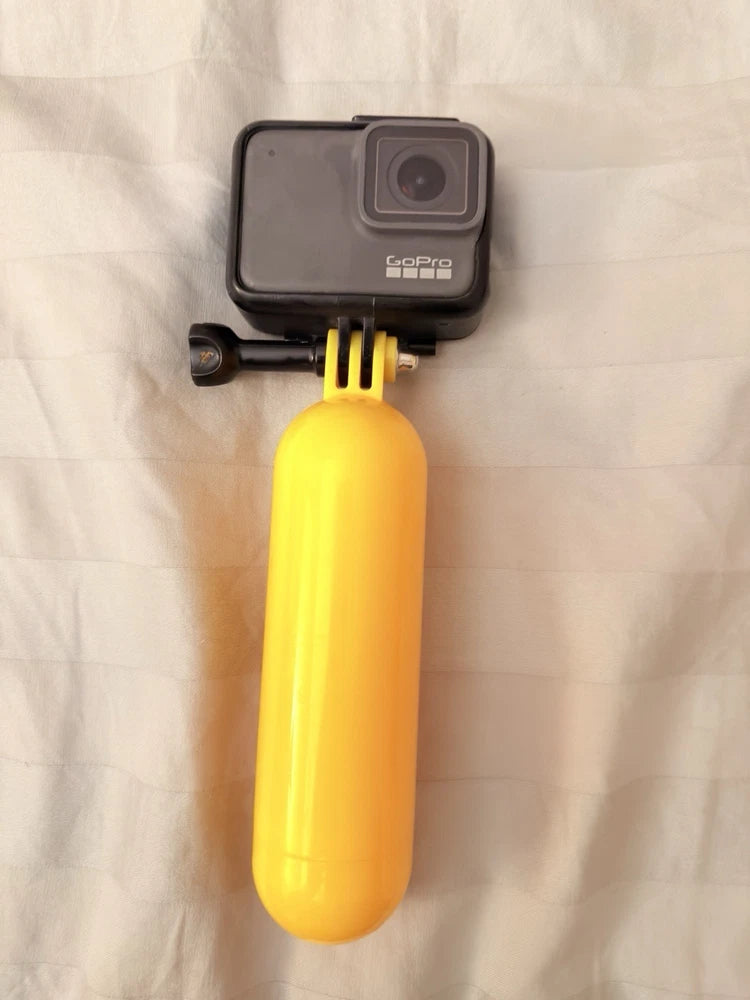 GoPro HERO7 waterproof action camera with yellow floating handgrip, front view
