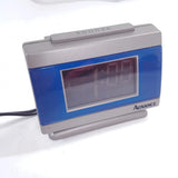 Mini digital travel alarm clock with blue sides, silver case, LCD display, Advance brand