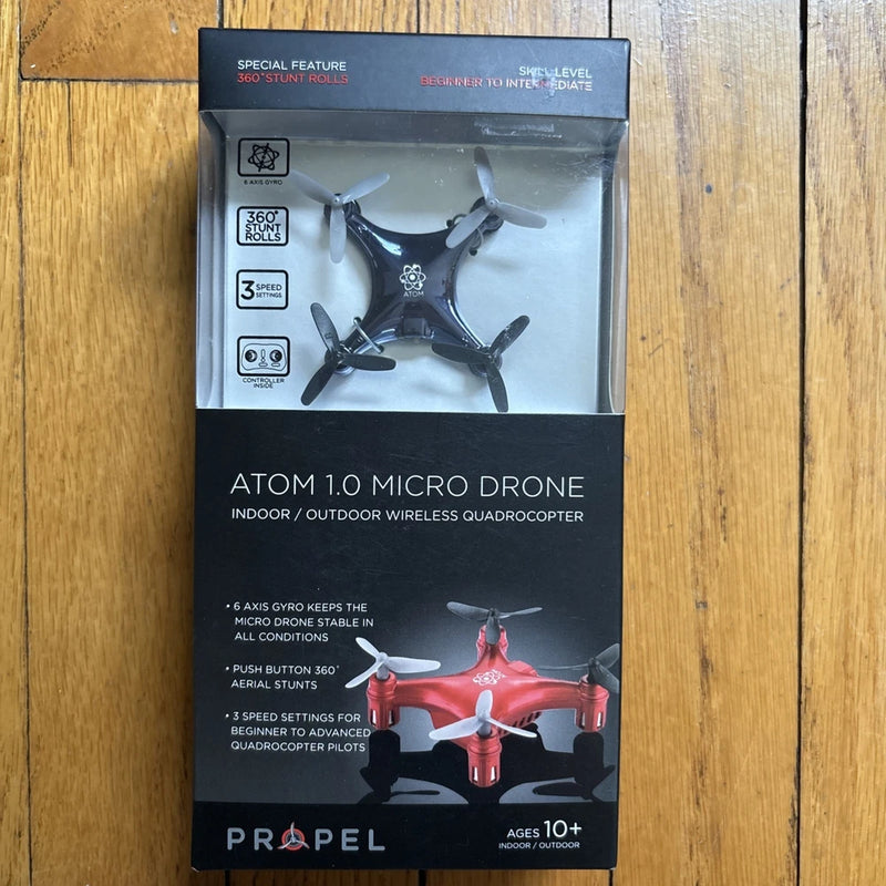Red micro quadcopter drone with four propellers, 360° roll capability