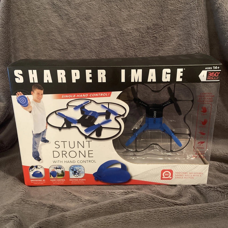Sharper Image hand-controlled stunt drone toy with blue quadcopter, LED lights, box