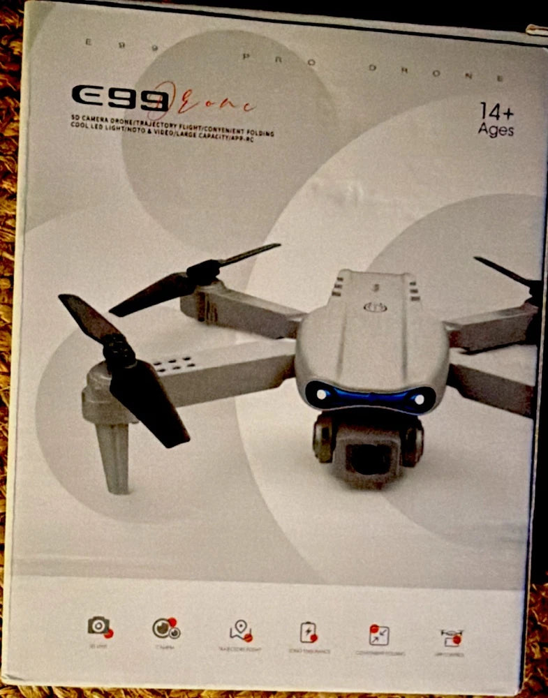 Gray foldable quadcopter drone with camera and four propellers
