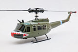 Green RC helicopter model with skid landing gear and rotor blades, RC WORLD marking