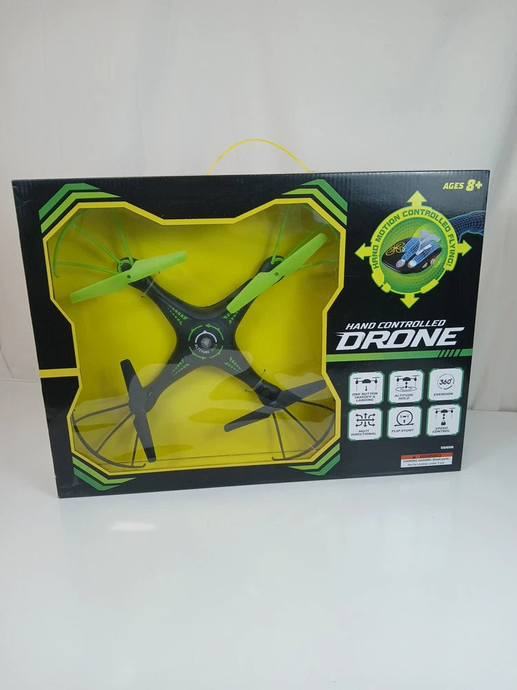Hand-controlled drone toy in retail box, green and black packaging