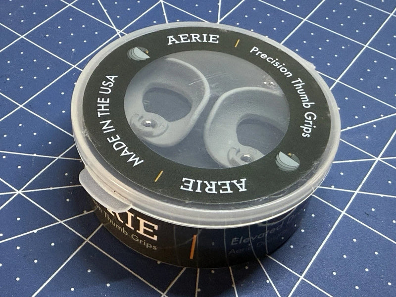 Round container with two gray drone thumb grips