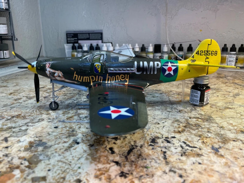 Built 1/32 Bell P-39Q Airacobra model with yellow nose, propeller, and landing stand