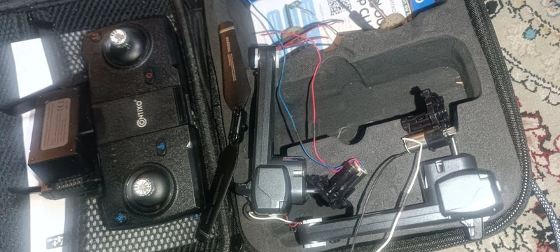 Drone parts kit in carry case with controller, drone body, prop guards, spare parts