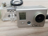 Silver GoPro action camera with round lens, status screen, and control buttons