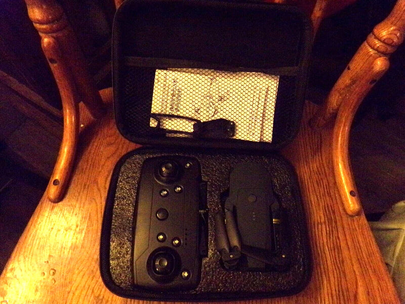 Black hard case with foldable drone and accessories, open view
