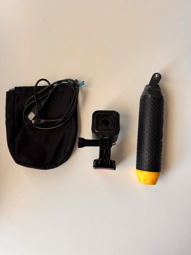Black action camera kit with pouch, small mount, and handheld grip with yellow base