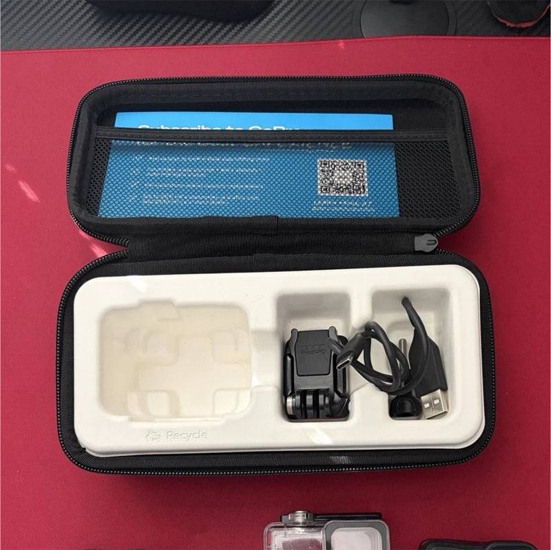 GoPro action camera case with camera, mounts, and USB cables inside