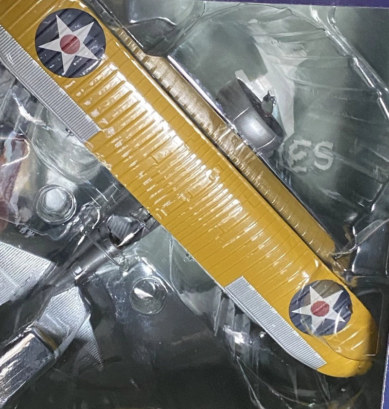 Yellow and silver model airplane with propeller and wing panels