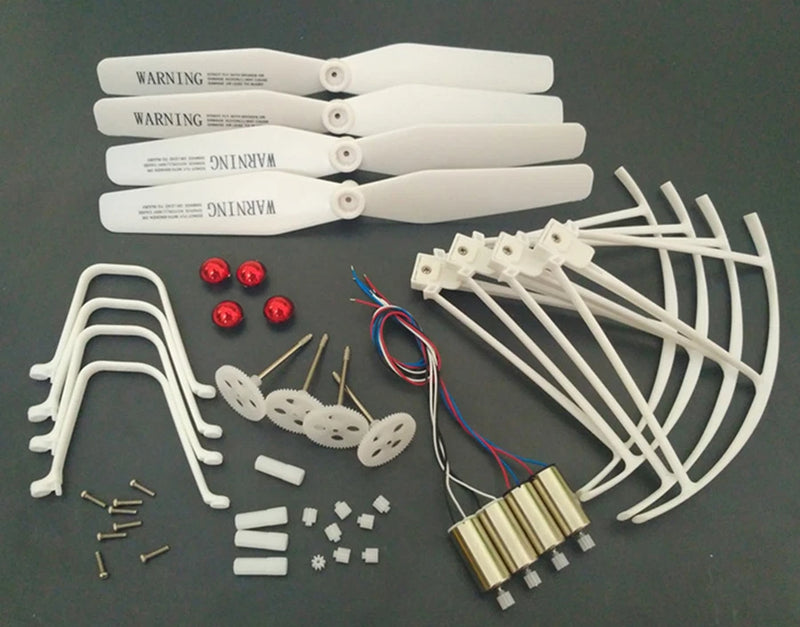 RC drone spare parts kit with motors, white frame arms, prop guards, screws and wiring