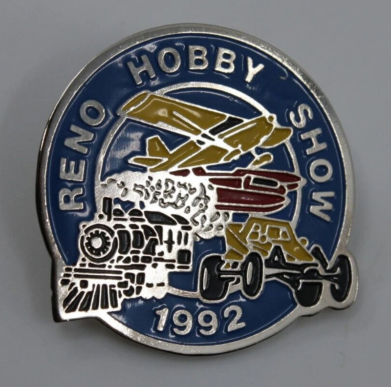 Round enamel lapel pin with blue background, hobby vehicles graphic and 1992 text