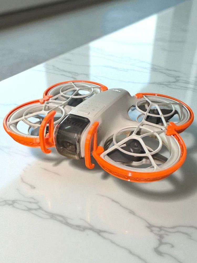 DJI Neo ultra-light prop guards with gray drone and bright orange safety frames
