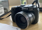 Black Fujifilm FinePix S1730 digital camera with zoom lens and wrist strap
