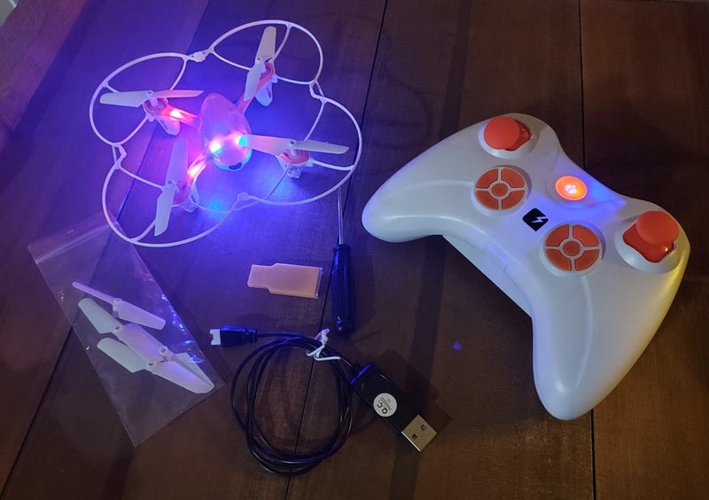 Mini drone with light-up propellers and white handheld controller