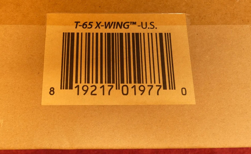 Cardboard collector’s edition box with barcode label and “T-65 X-WING” text