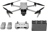 White quadcopter drone with front gimbal, controller, and two batteries