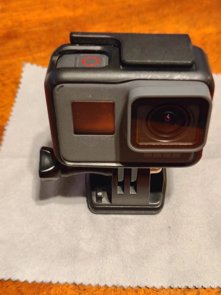 Black action camera with front lens and small status display