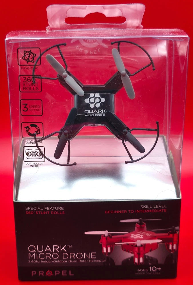 Micro quadcopter drone in retail package, clear front window showing propellers