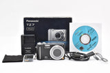 Panasonic LUMIX DMC-TZ7 digital camera kit with battery, strap, cables, and software CD