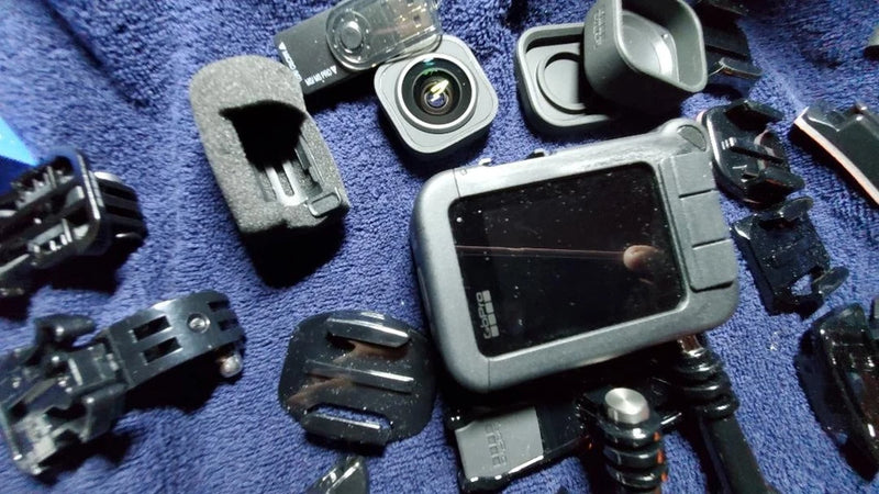 Pre-owned GoPro HERO10 Black action camera with touchscreen and mounting accessories