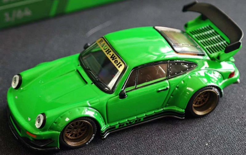 Green die-cast race car model, side view, black wheels and detailed bodywork.