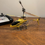 Yellow and black 3-channel mini RC helicopter with metal frame and spinning rotor mast