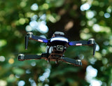 Black foldable quadcopter drone with Full HD camera and four propellers