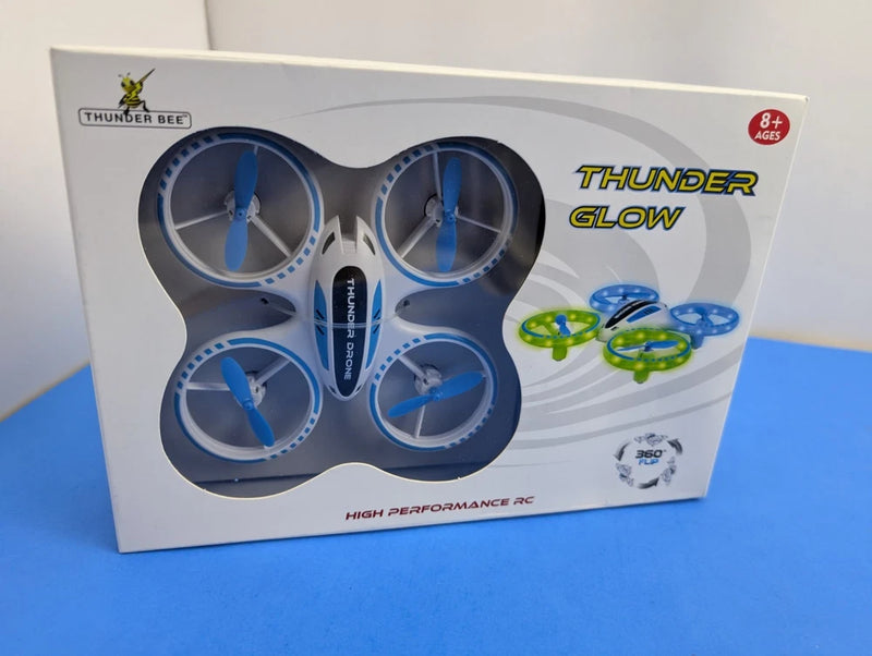 Blue remote control quadcopter drone with lights, shown in retail box