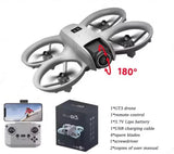 Mini quadcopter RC drone with gray body and four propellers, shown with remote and box