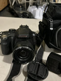 Black Fujifilm Finepix digital camera with lens and lens cap