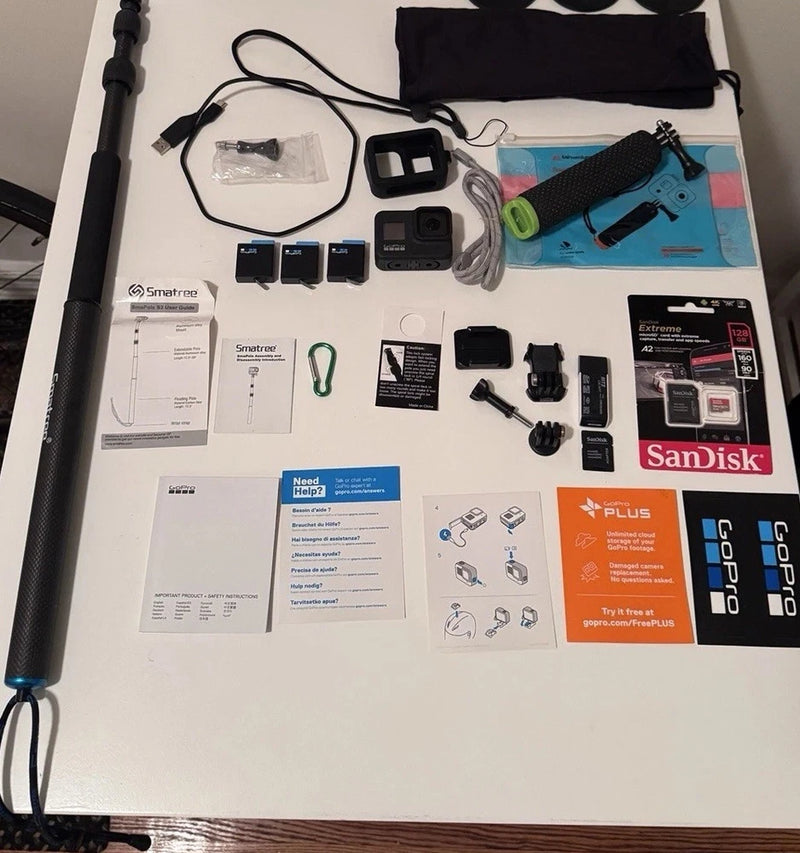 GoPro action camera accessories kit with camera, mounts, battery, cables, and microSD card
