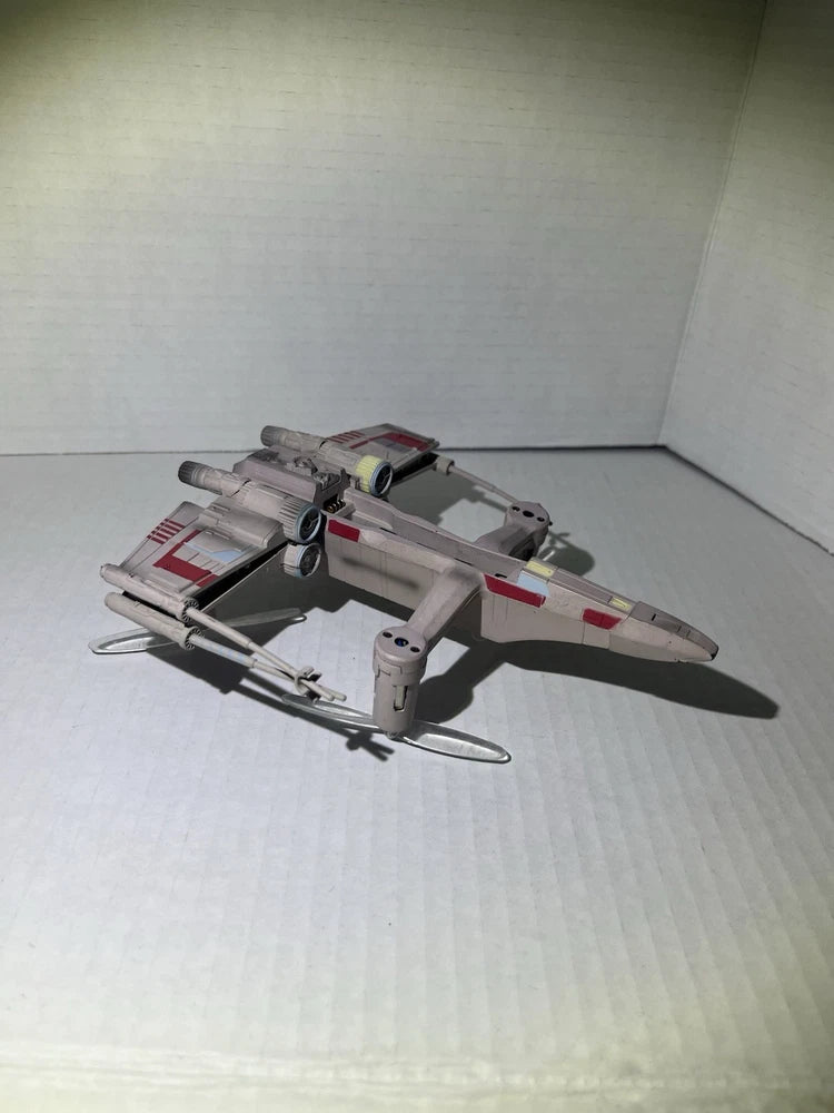 Gray T-65 X-Wing style battle drone with wings and landing gear, used
