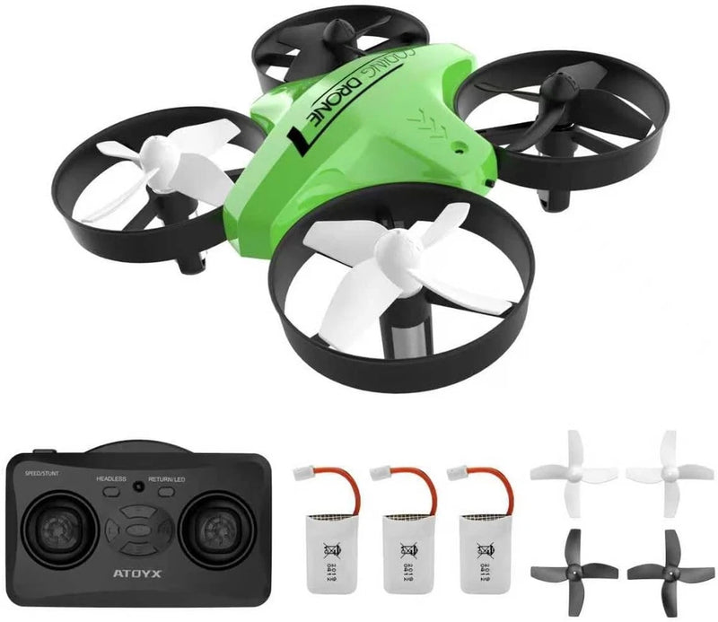 Green mini quadcopter drone with four propellers, remote controller, and extra battery packs