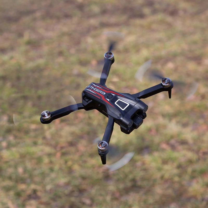 Black and gray FPV quadcopter drone with four propellers and camera on front
