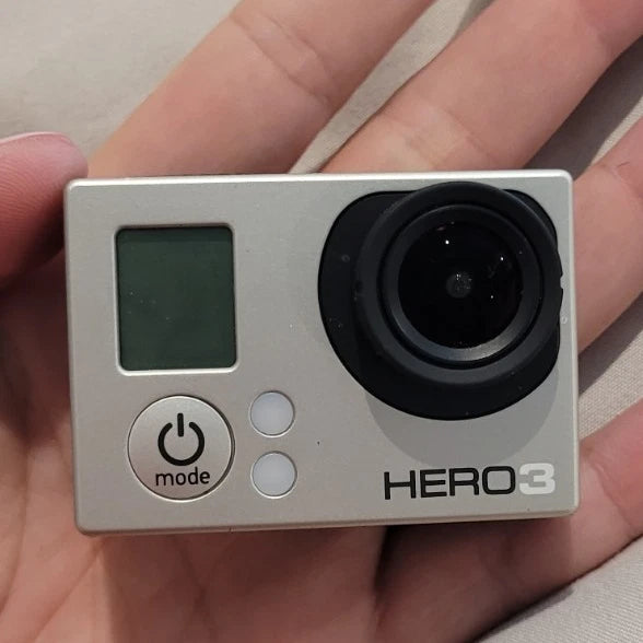 GoPro HERO3 action camera in silver with LCD screen, black lens, and power mode button
