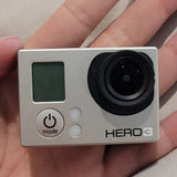GoPro HERO3 action camera in silver with LCD screen, black lens, and power mode button
