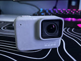 White waterproof action camera with square housing, front lens and GoPro logo