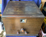 Vintage battery receiver tube radio housing with metal front panel and knobs