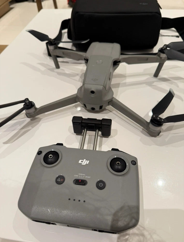 Gray DJI drone with four propellers, top controls and camera housing