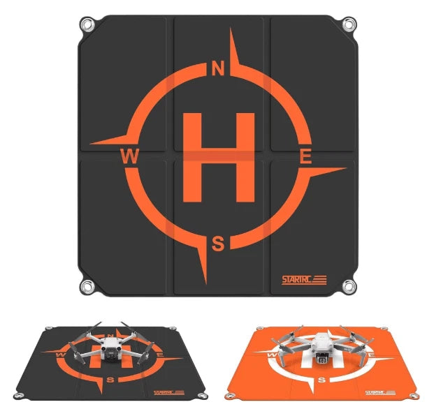 Foldable drone landing pad, dark gray with orange compass icon and starburst marking