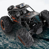 Off-road RC monster truck with roof HD camera, rugged tires and orange trim accents