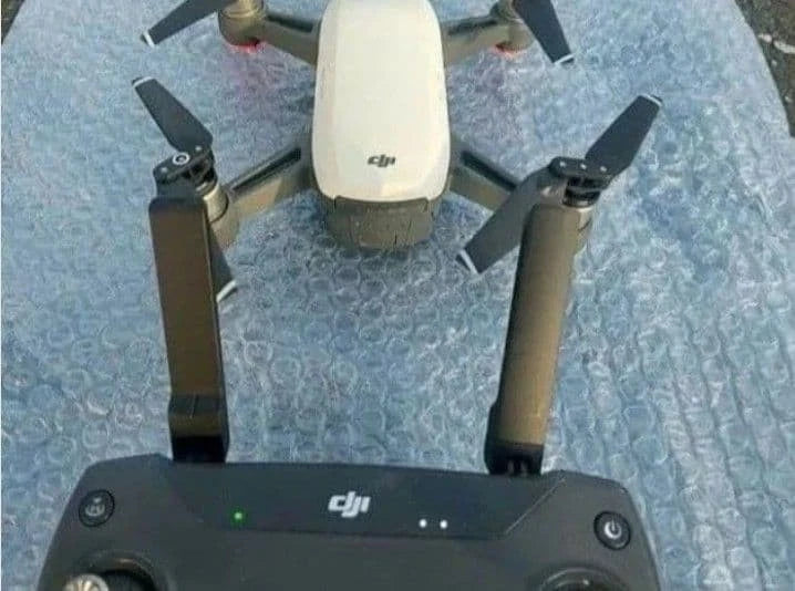 DJI drone controller with connected Spark drone and propellers